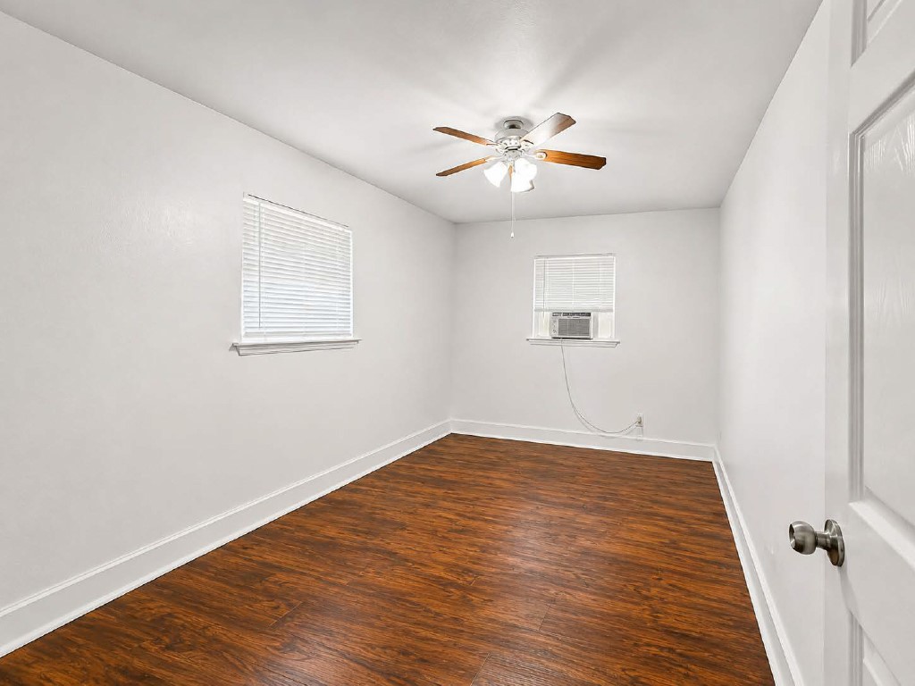 610 Gunter Street Austin, TX 78702 - Photo 11 of 16 Hardwood-style flooring and a ceiling fan provide comfort in this generously proportioned room.