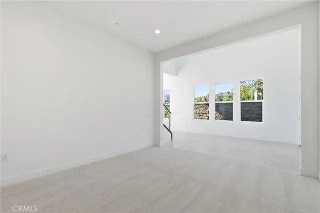 a kitchen with stainless steel appliances kitchen island granite countertop a stove a sink and a refrigerator