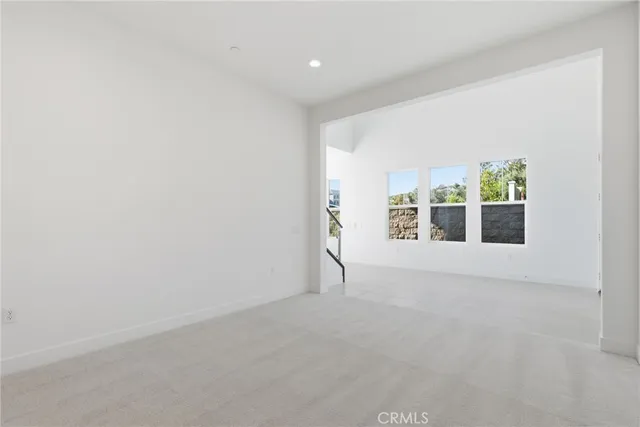 a kitchen with stainless steel appliances kitchen island granite countertop a stove a sink and a refrigerator