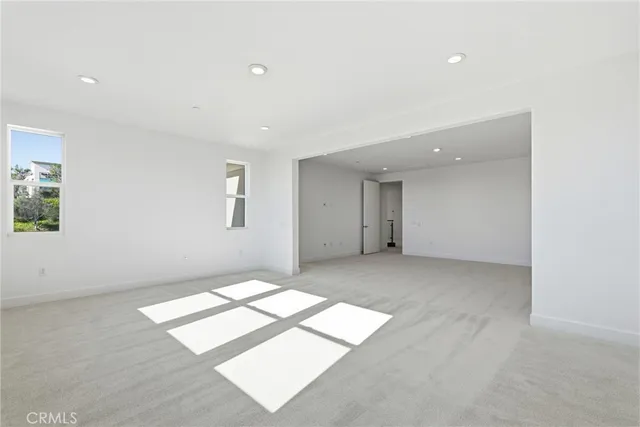 a view of an empty room with windows and closet