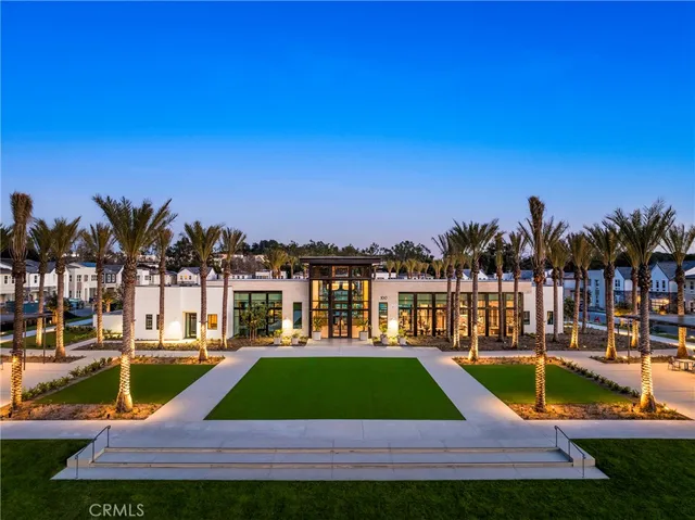 a front view of a house with garden and sitting area