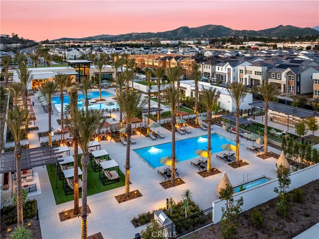a living room with furniture a fireplace and a large window