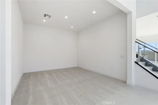 a view of a kitchen with a sink and dishwasher a refrigerator with white cabinets