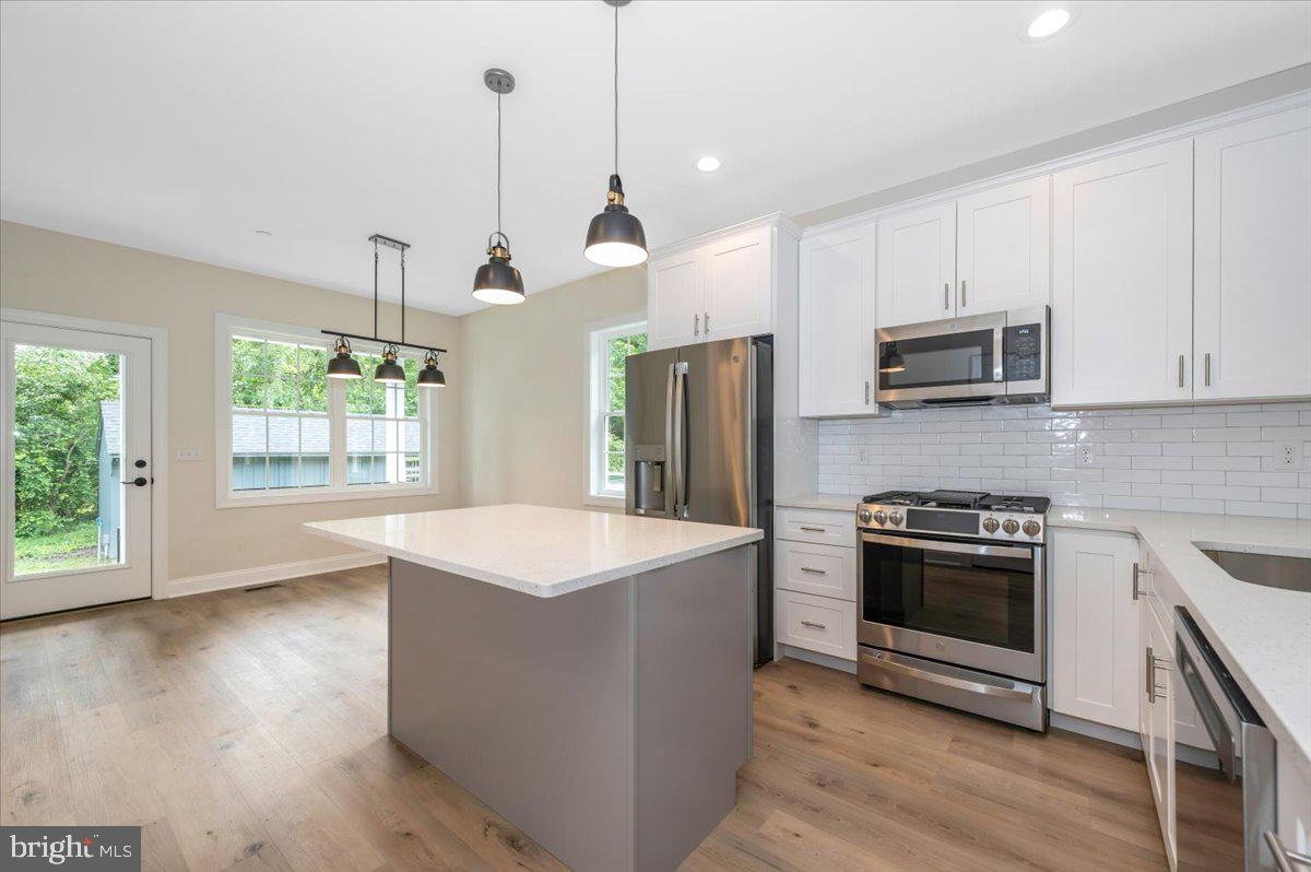 216 Brooks Lane St. Michaels, MD 21663 - Photo 18 of 37 a kitchen with stainless steel appliances granite countertop a stove a sink and a refrigerator