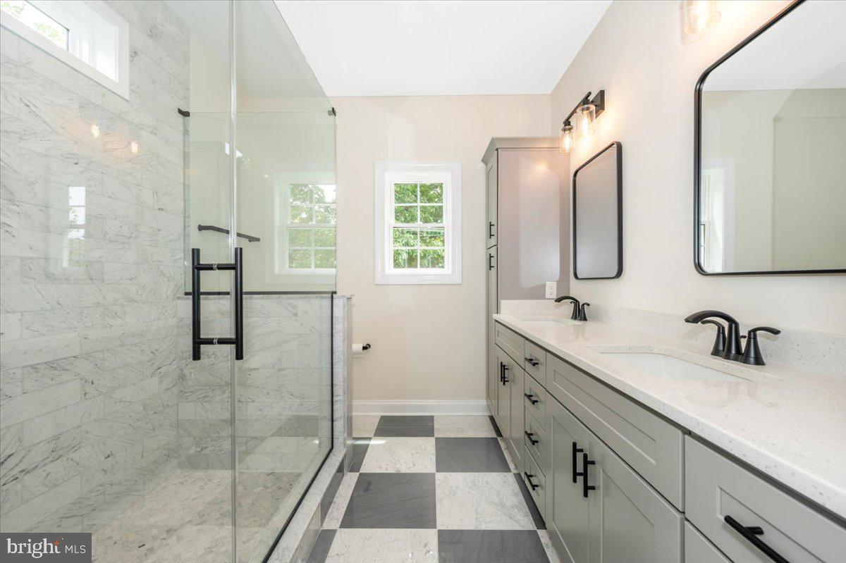 216 Brooks Lane St. Michaels, MD 21663 - Photo 26 of 37 a spacious bathroom with a double vanity sink mirror and shower