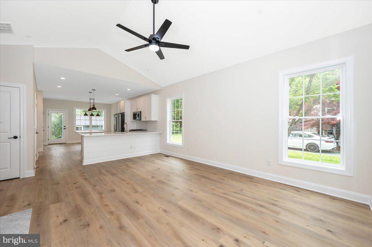 216 Brooks Lane St. Michaels, MD 21663 - Photo 5 of 37 a view of a livingroom with a ceiling fan & wooden floor