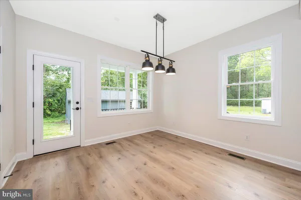 an empty room with windows and outdoor view