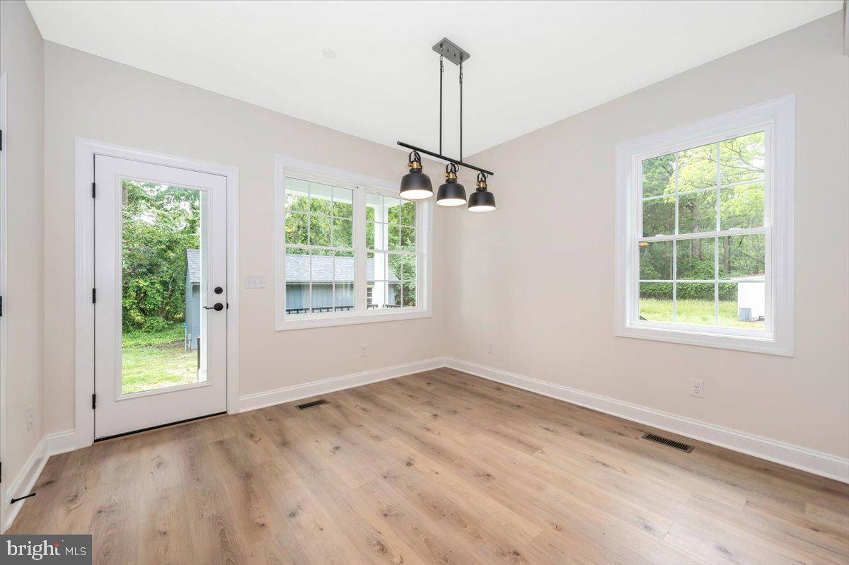 216 Brooks Lane St. Michaels, MD 21663 - Photo 8 of 37 an empty room with windows and outdoor view