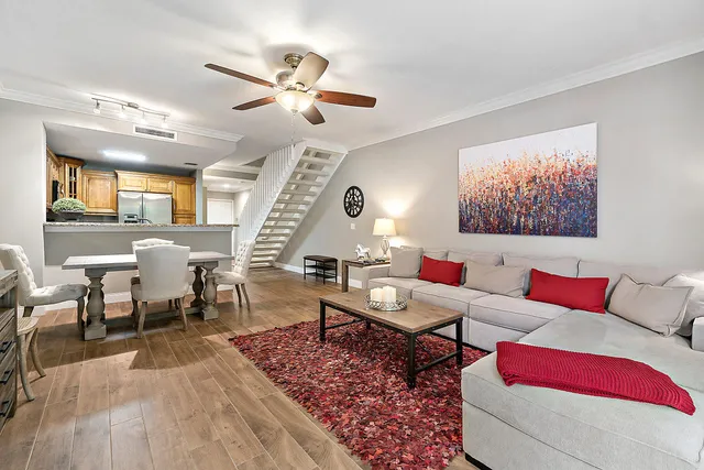 a living room with furniture and wooden floor