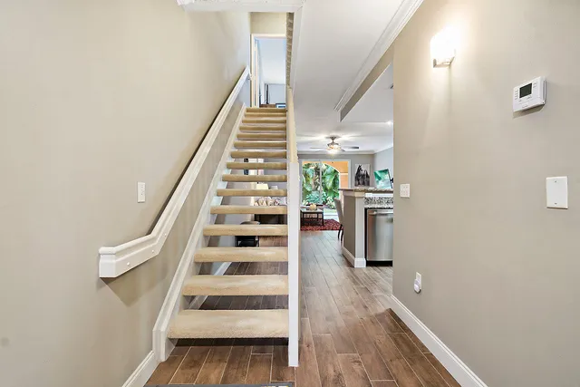 a kitchen with kitchen island granite countertop a sink and a refrigerator