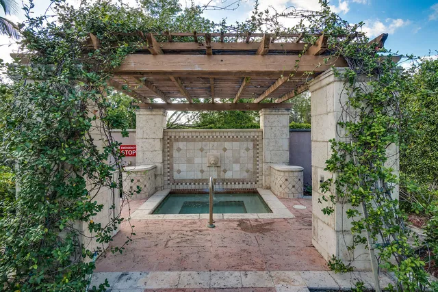 a living room with furniture a rug and a floor to ceiling window