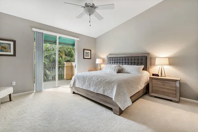 a spacious bedroom with a bed and a lamp