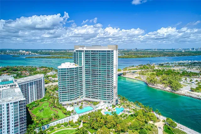 a dining table with chairs and potted plant