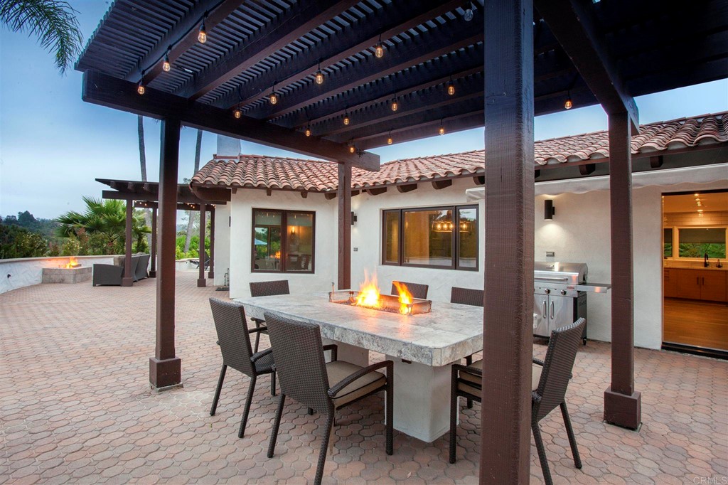 17143 Los Morros Rancho Santa Fe, CA 92067 - Photo 16 of 32 Large covered pergola with built-in dining area and fire pit to stay warm.