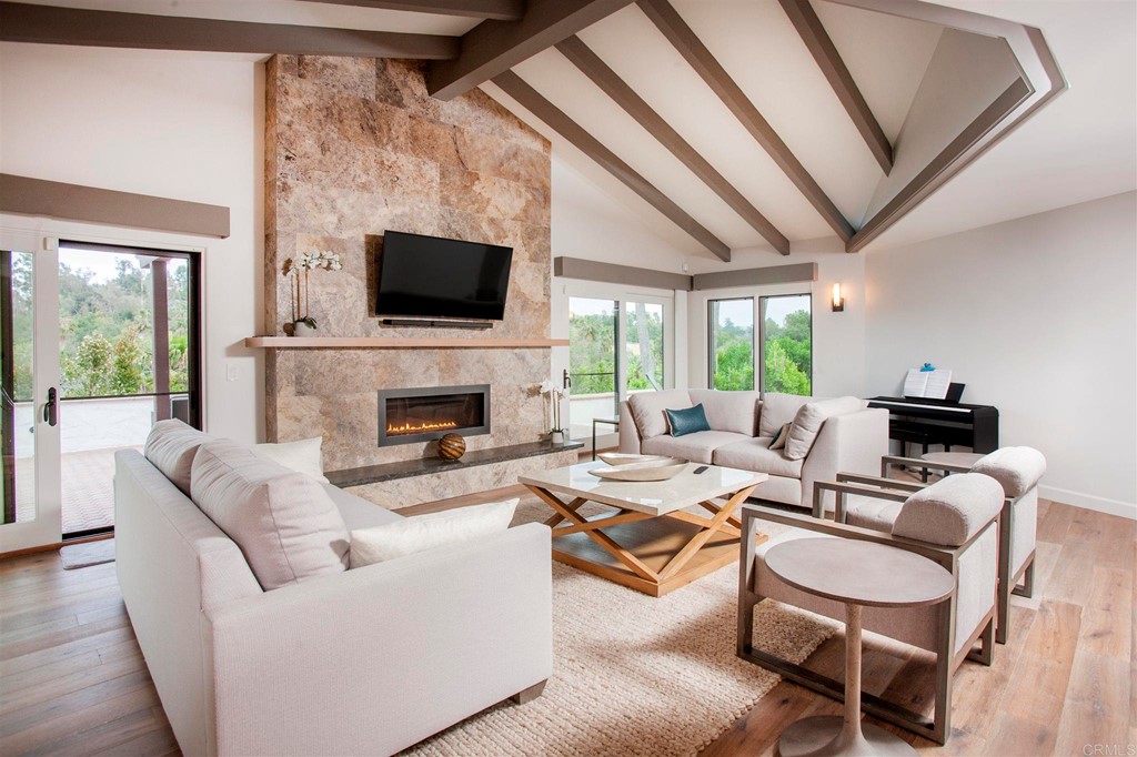 17143 Los Morros Rancho Santa Fe, CA 92067 - Photo 9 of 32 Vaulted ceilings and large fireplace with views to the exterior make this a lovely room to enjoy.