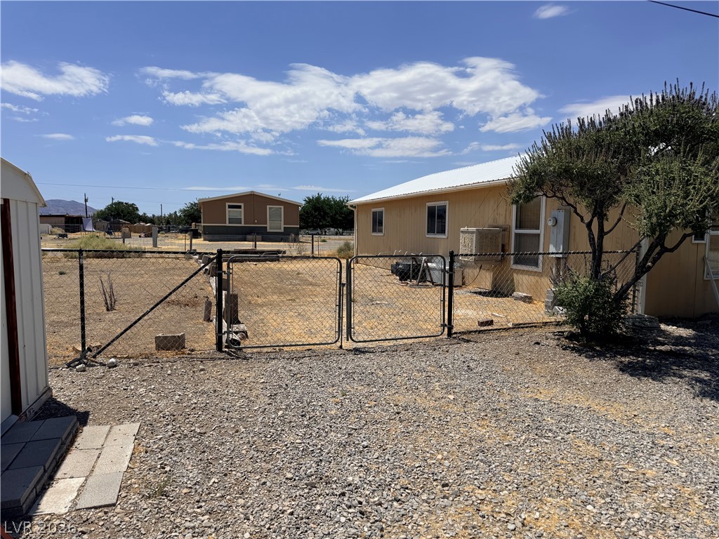 1391 West Dyer Road Pahrump, NV 89048 - Photo 27 of 50 Securely fenced yard space for outdoor activities and storage.