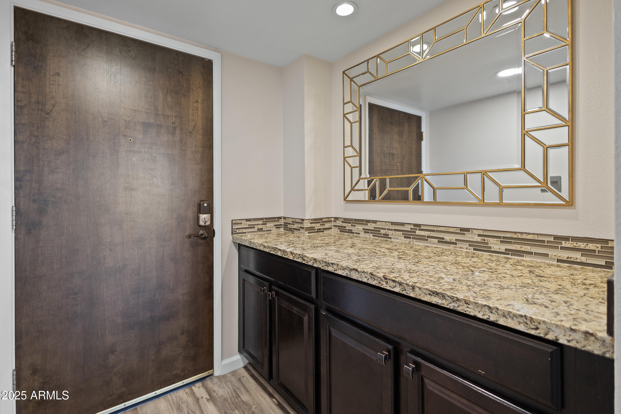 7920 East Camelback Road, Unit 601 Scottsdale, AZ 85251 - Photo 1 of 31 a bathroom with a granite countertop sink and a mirror