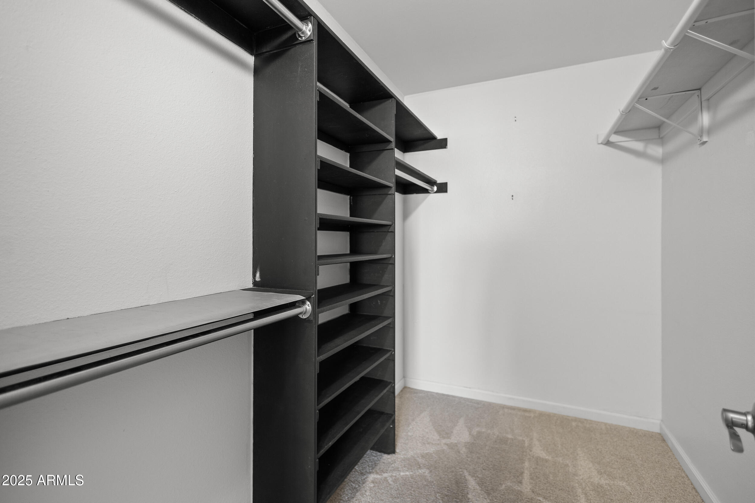 7920 East Camelback Road, Unit 601 Scottsdale, AZ 85251 - Photo 13 of 31 a view of walk in closet with clothes and shoes