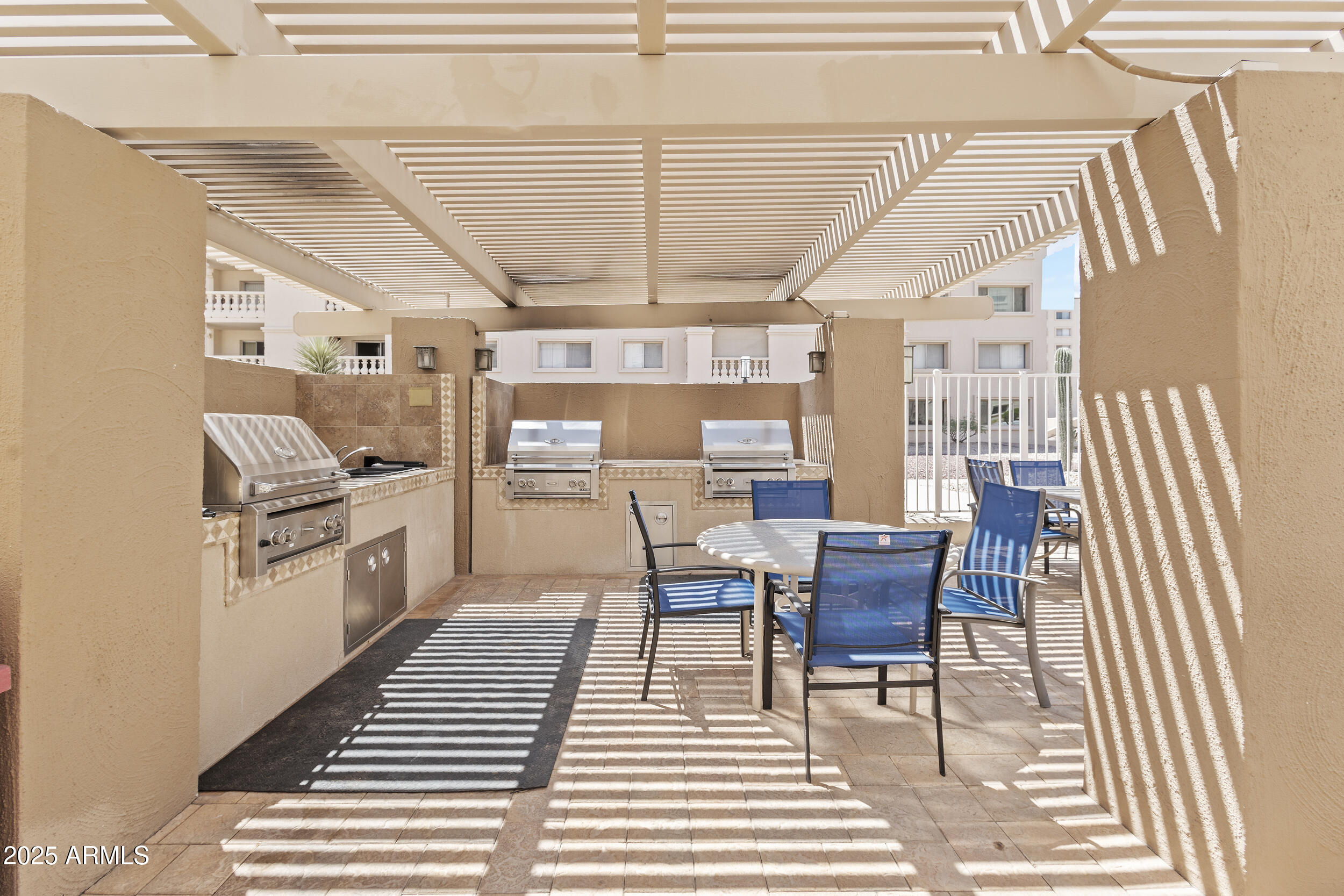 7920 East Camelback Road, Unit 601 Scottsdale, AZ 85251 - Photo 19 of 31 a dining room with furniture and a kitchen view