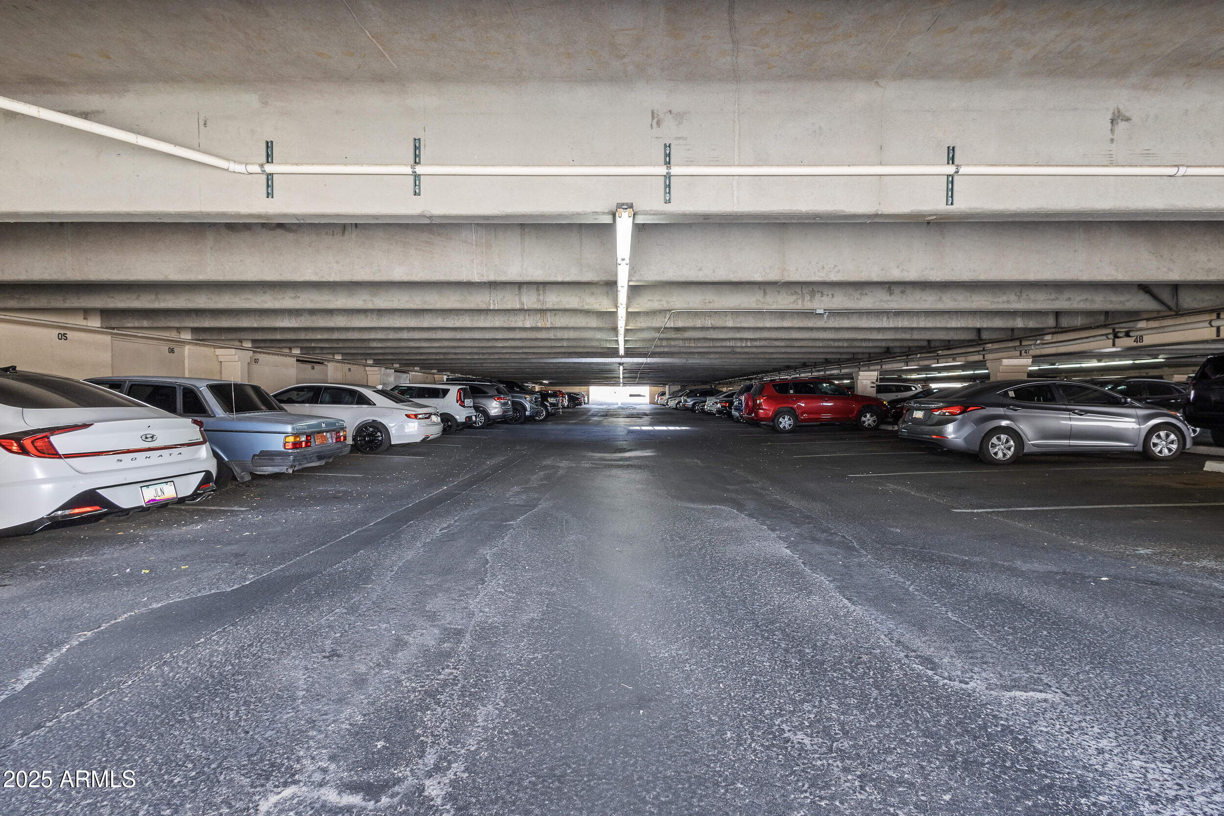 7920 East Camelback Road, Unit 601 Scottsdale, AZ 85251 - Photo 27 of 31 a view of parking with cars