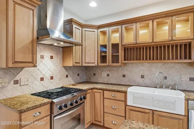 a kitchen with stainless steel appliances granite countertop a stove and a sink