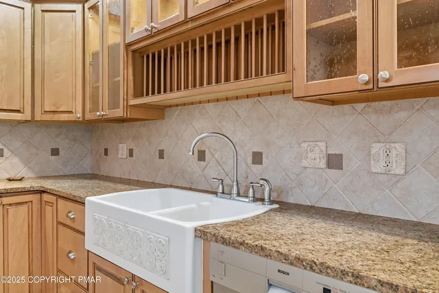 a kitchen with granite countertop a sink and a stove