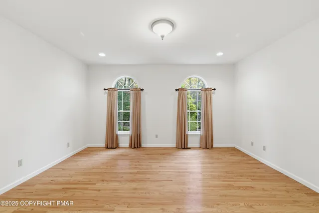 an empty room with windows and closet