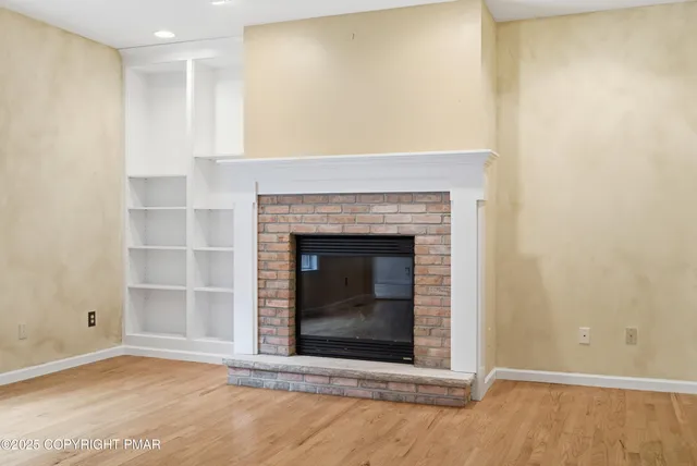 a view of an empty room with a fireplace