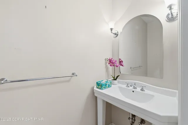a bathroom with a sink mirror and vanity