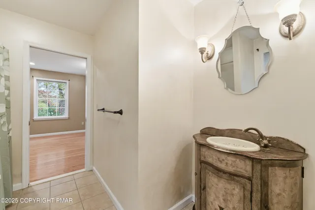 a bathroom with a granite countertop sink a mirror and shower