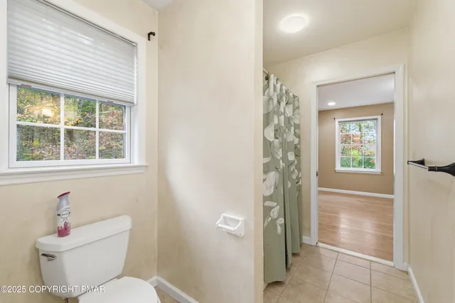 a white toilet sitting next to a bathroom sink