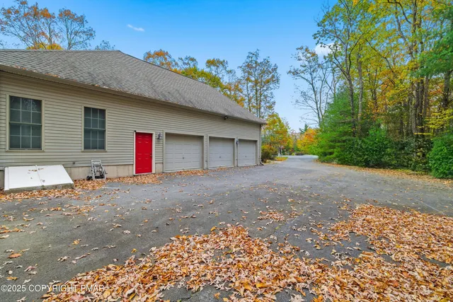 a view of a house with a yard and garage