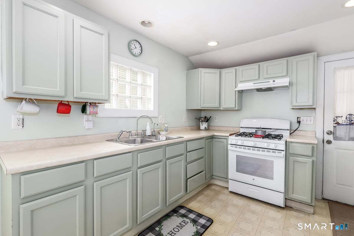 70 Dodgingtown Road Bethel, CT 06801 - Photo 6 of 27 a kitchen with cabinets appliances a sink and a window