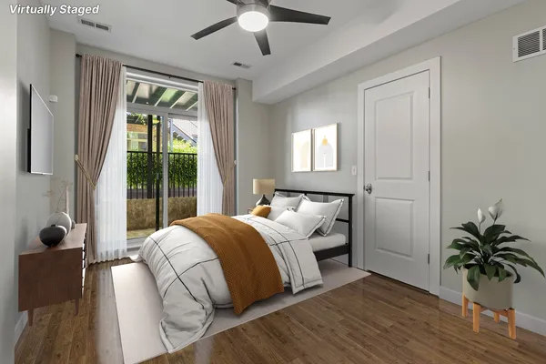 a bedroom with a bed lamp and a large window