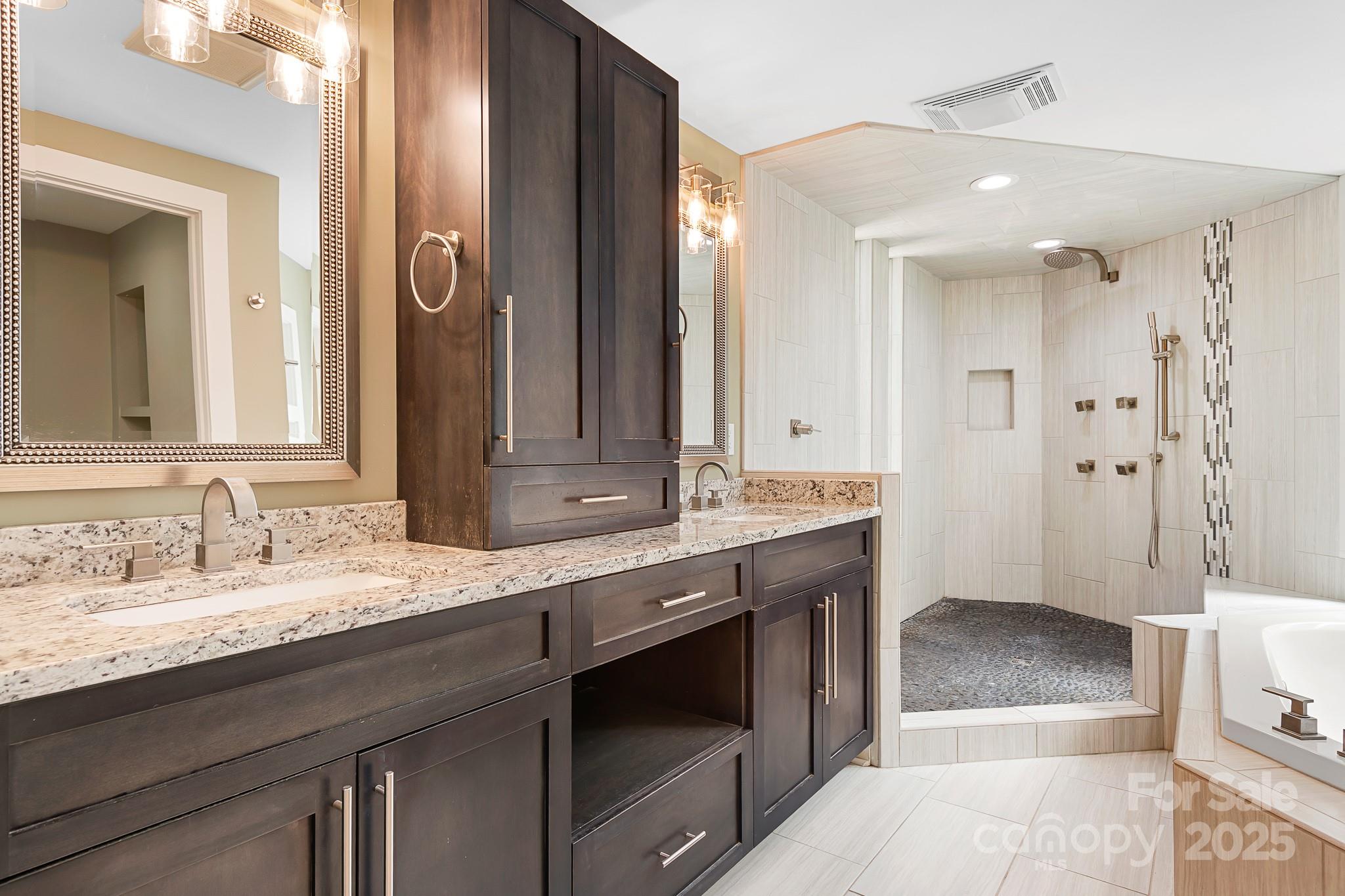 3249 Ivey Creek Road Maiden, NC 28650 - Photo 32 of 45 a spacious bathroom with a granite countertop sink a toilet a mirror and shower