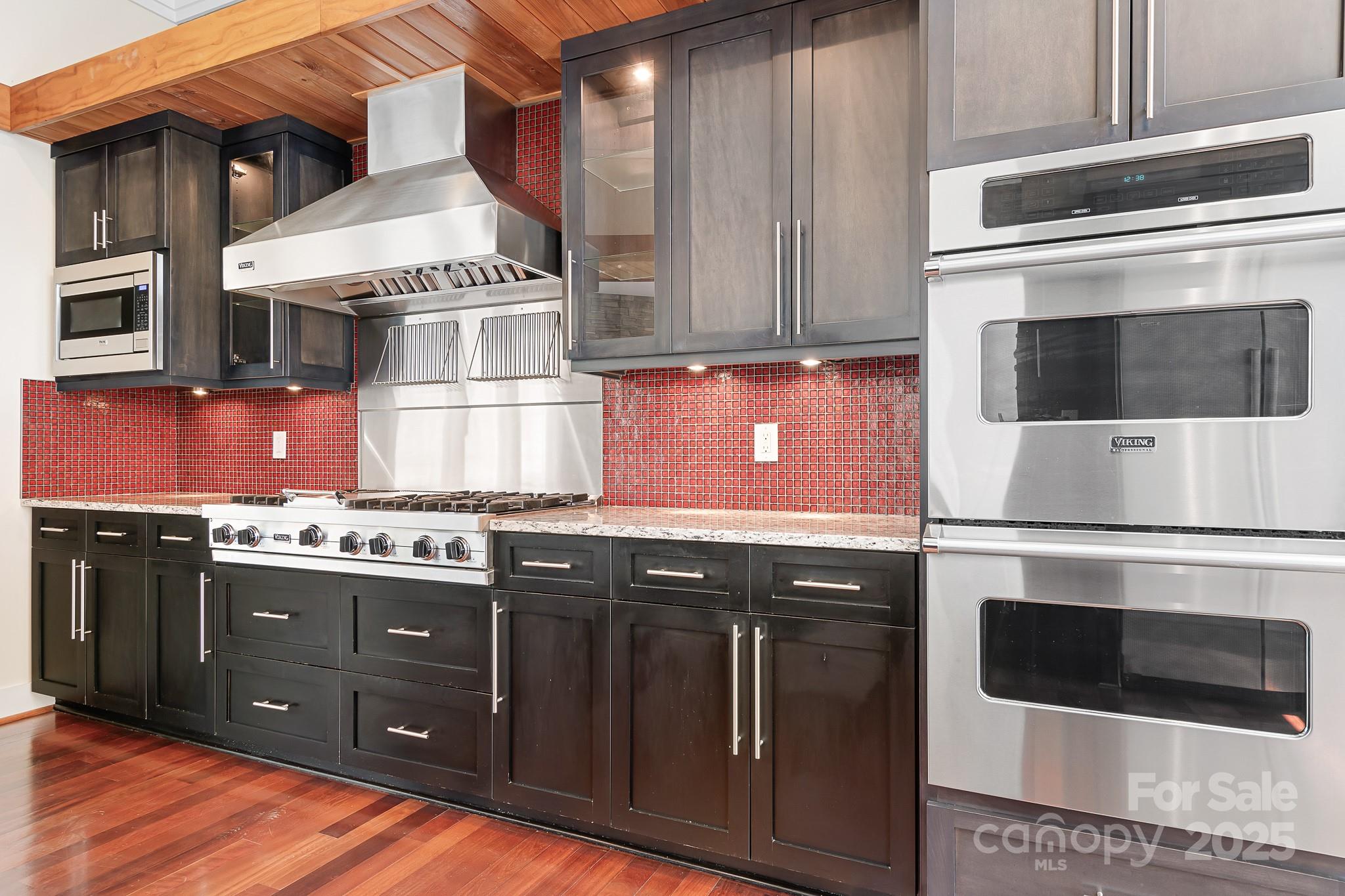 3249 Ivey Creek Road Maiden, NC 28650 - Photo 4 of 45 a kitchen with stainless steel appliances granite countertop a stove and a microwave