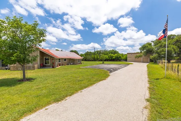 a front view of house with yard and trees