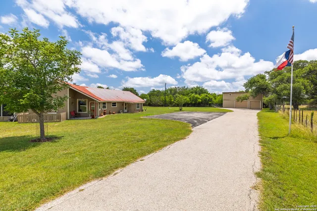 a front view of house with yard and trees