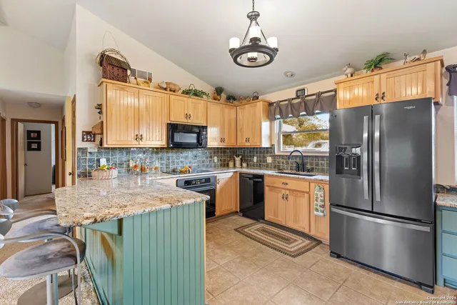 a spacious bedroom with a large bed and a chandelier