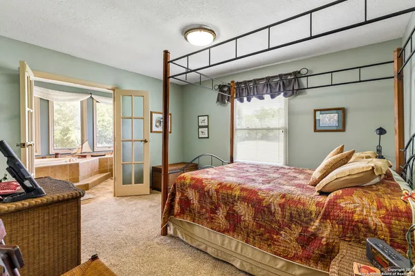 a spacious bathroom with a large tub and sink