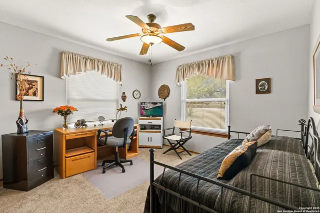 a bathroom with a sink a toilet and shower curtain