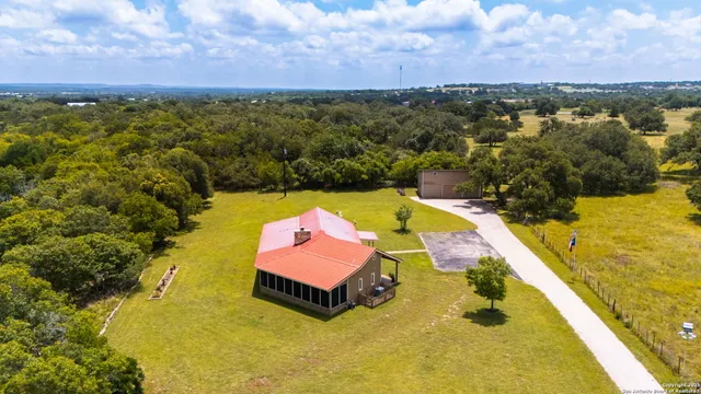 a view of a swimming pool with lawn chairs and couches