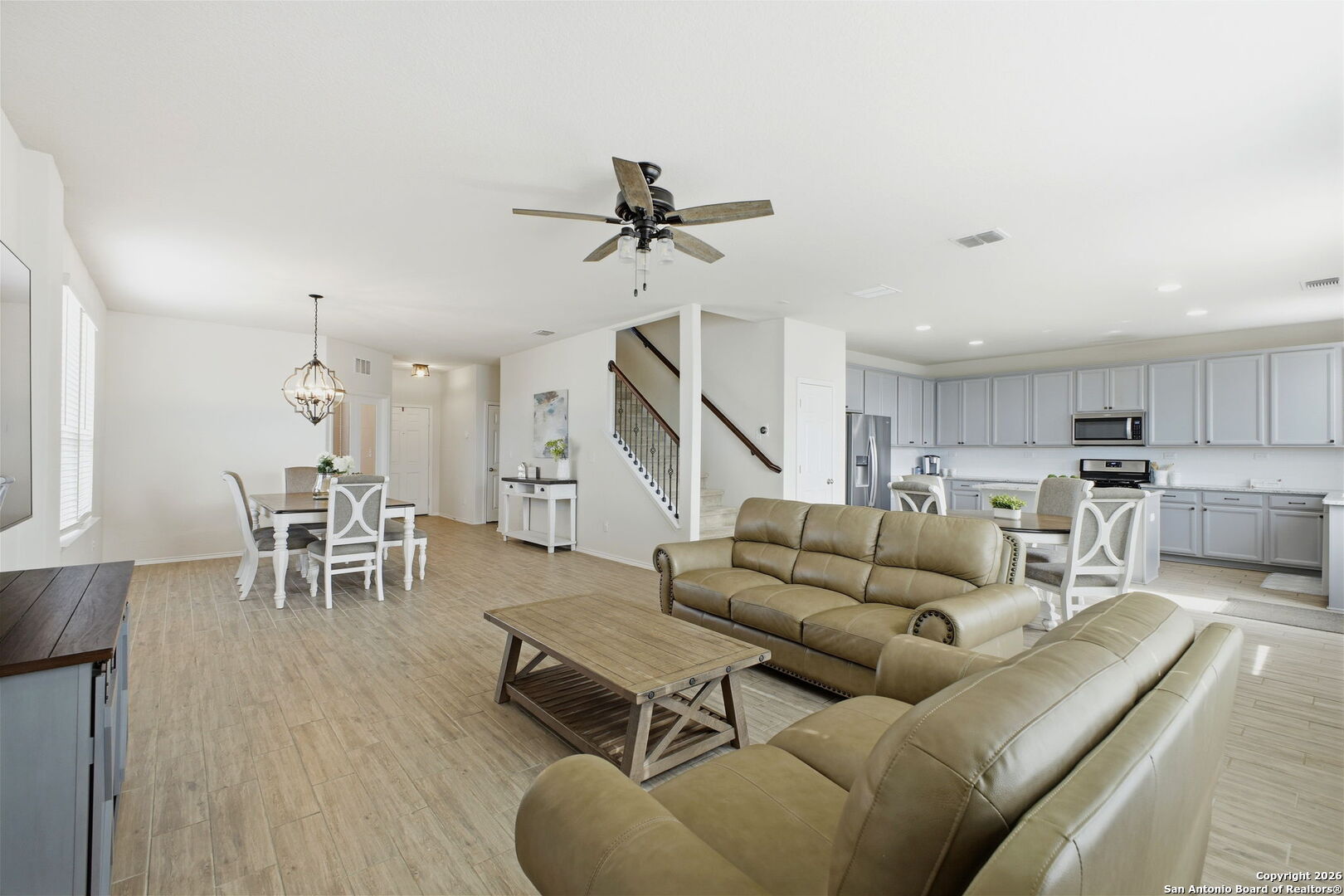 7710 Pecos Boerne, TX 78015 - Photo 12 of 34 a living room with furniture kitchen view and a wooden floor