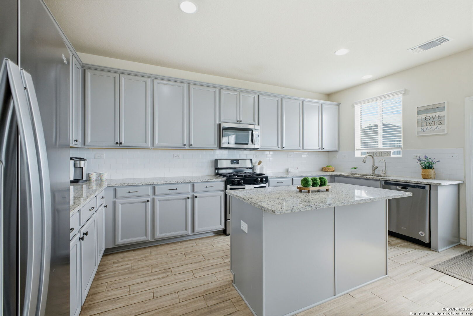 7710 Pecos Boerne, TX 78015 - Photo 16 of 34 a kitchen with stainless steel appliances granite countertop a refrigerator sink and stove
