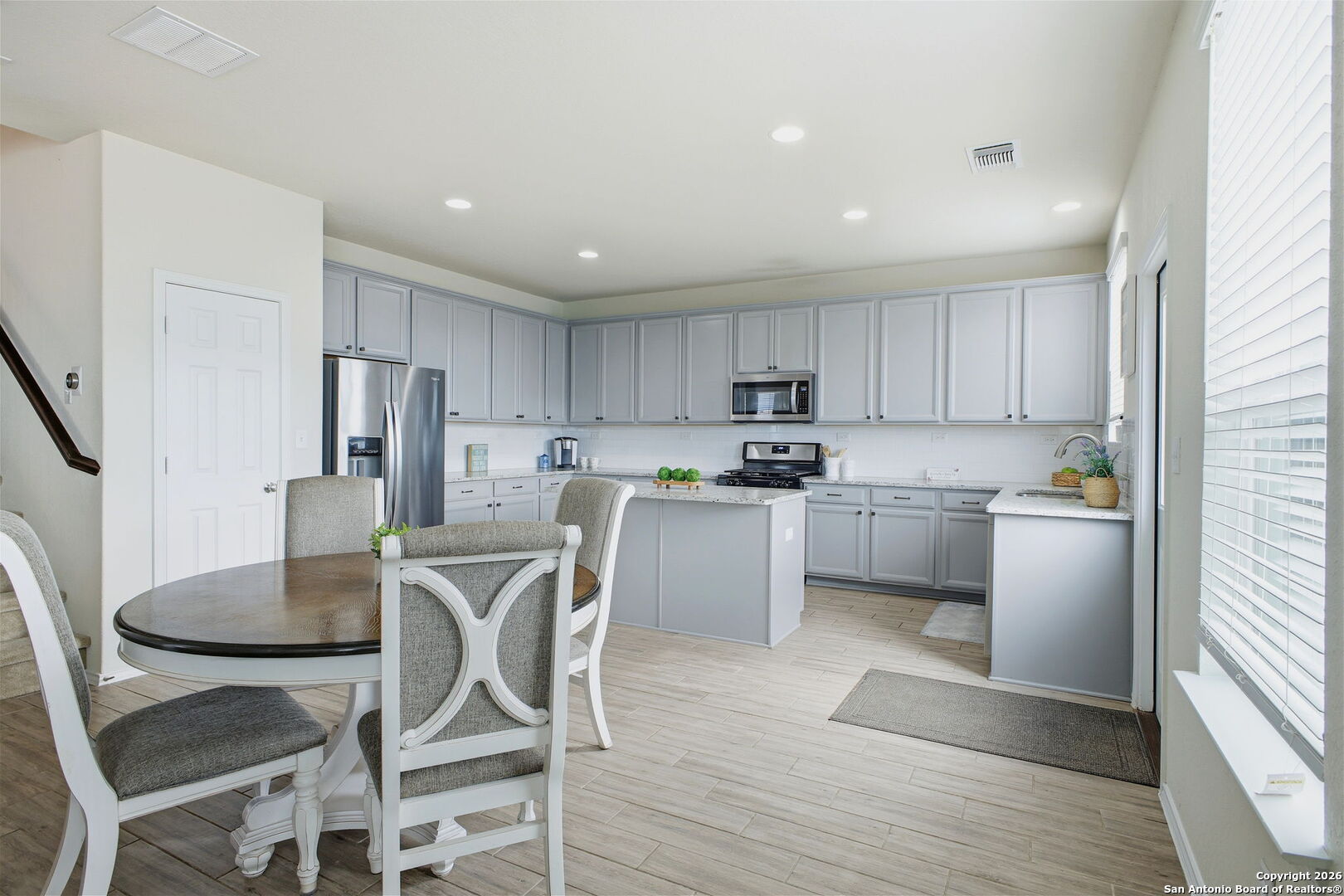 7710 Pecos Boerne, TX 78015 - Photo 17 of 34 a kitchen with white cabinets stainless steel appliances and refrigerator