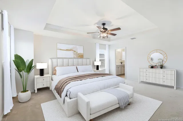 a bedroom with a bed and ceiling fan