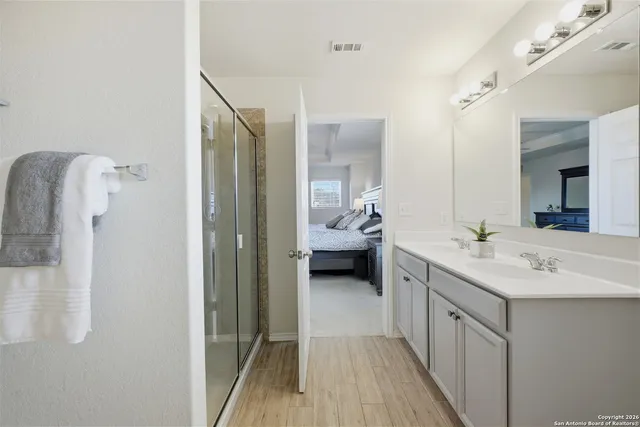 a en suite bathroom with a sink a mirror and a shower