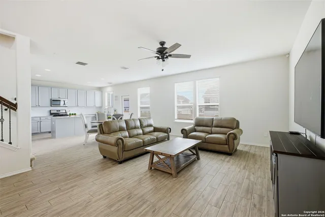 a living room with furniture and a wooden floor