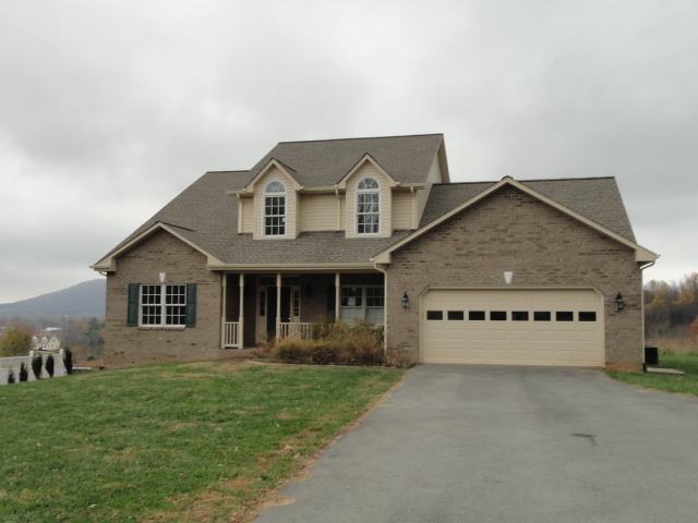 3721 Callaway Road Rocky Mount, VA 24151 - Photo 1 of 1 a front view of a house with a yard and garage