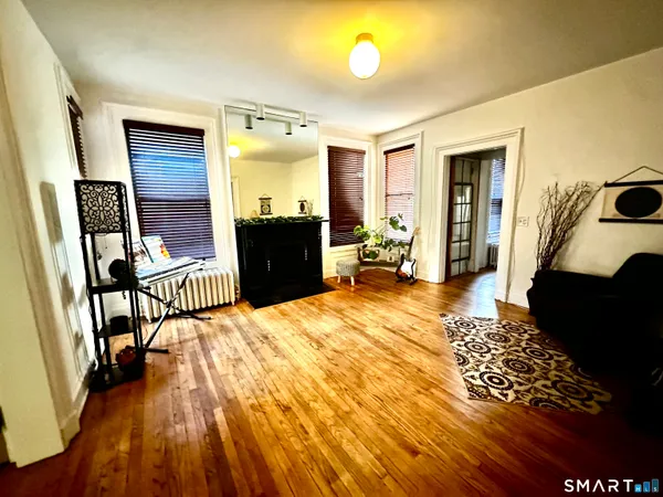 a bedroom with furniture and a window